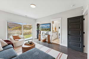 Living room with dark wood-style flooring and baseboards