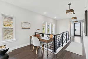 Home office featuring dark wood-style flooring and recessed lighting