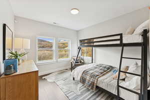 Bedroom featuring wood finished floors and baseboards