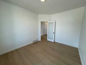 Empty room featuring baseboards and wood finished floors