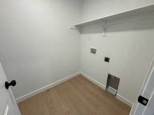 Washroom with wood finished floors, washer hookup, and hookup for an electric dryer