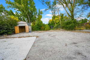 View of yard/parking  featuring a shed