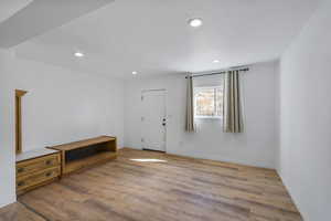 Foyer featuring light wood finished floors and recessed lighting