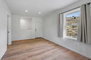 Unfurnished room with light wood-style floors and recessed lighting