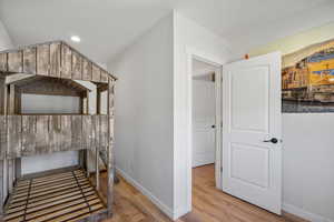 Bedroom with light wood finished floors and recessed lighting