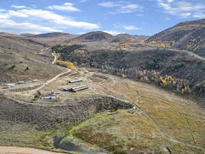Aerial overview of property's location with a mountain backdrop and rural landscape