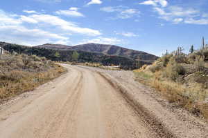View of dirt / gravel road featuring a mountain view