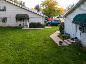 View of green lawn with entry steps