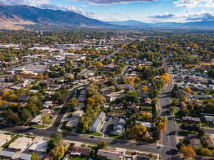 Aerial view of property's location featuring a mountainous background and nearby suburban area
