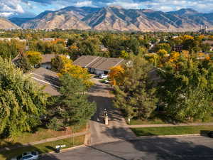 Aerial view of residential area with a mountain backdrop and a tree filled landscape