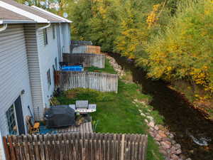 Fenced yard featuring radiator and a water view