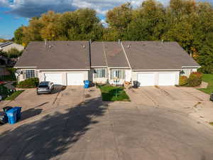 View of front of property featuring driveway and a shingled roof