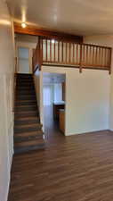 Stairs featuring wood finished floors and baseboards