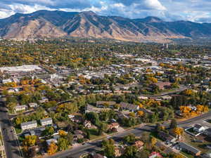 View of property location featuring a mountain backdrop and a tree filled landscape