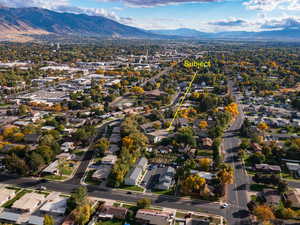 Aerial overview of property's location featuring a mountainous background and nearby suburban area