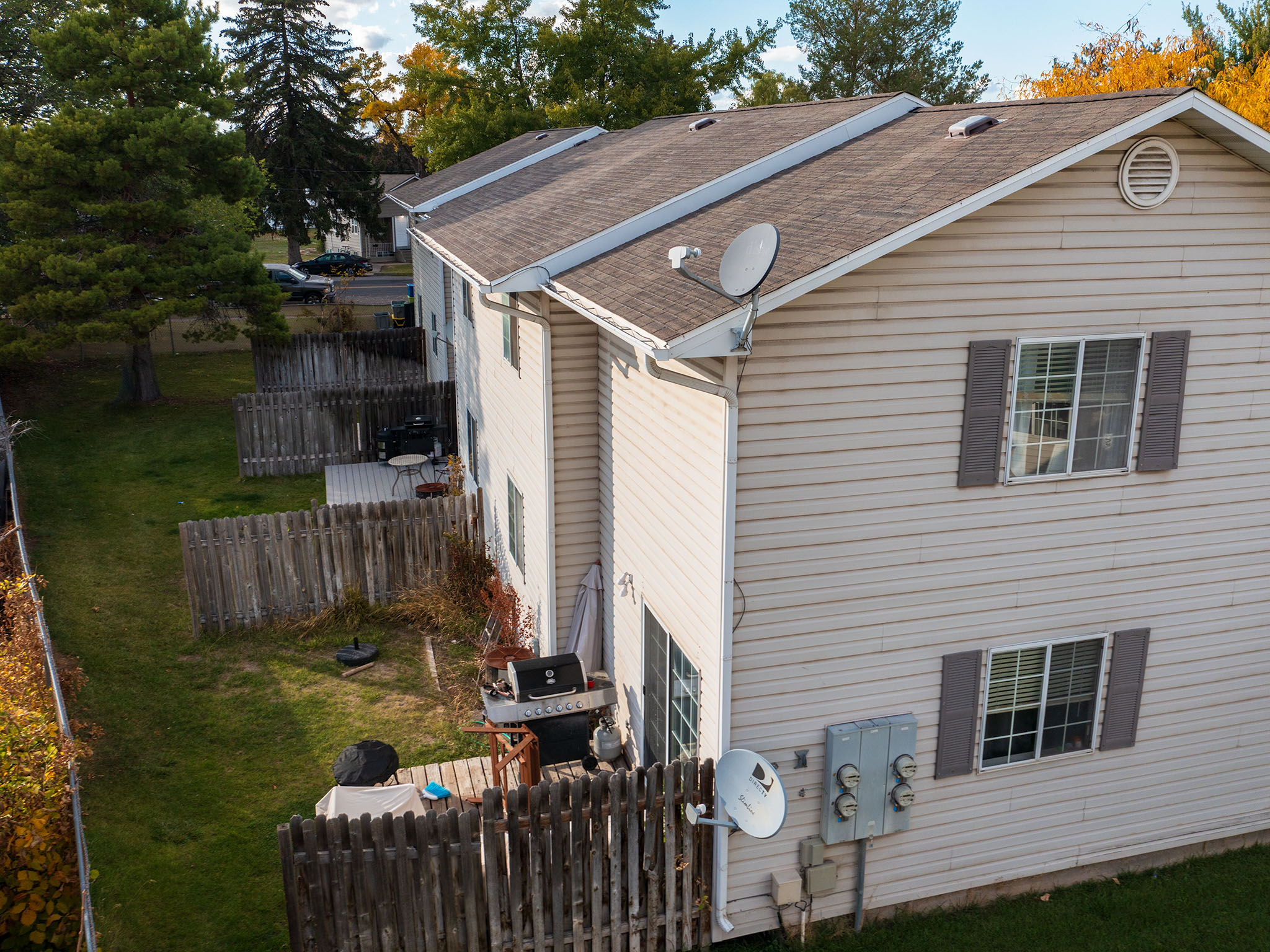 View of side of property with a shingled roof
