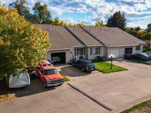 Single story home featuring roof with shingles, driveway, and an attached garage