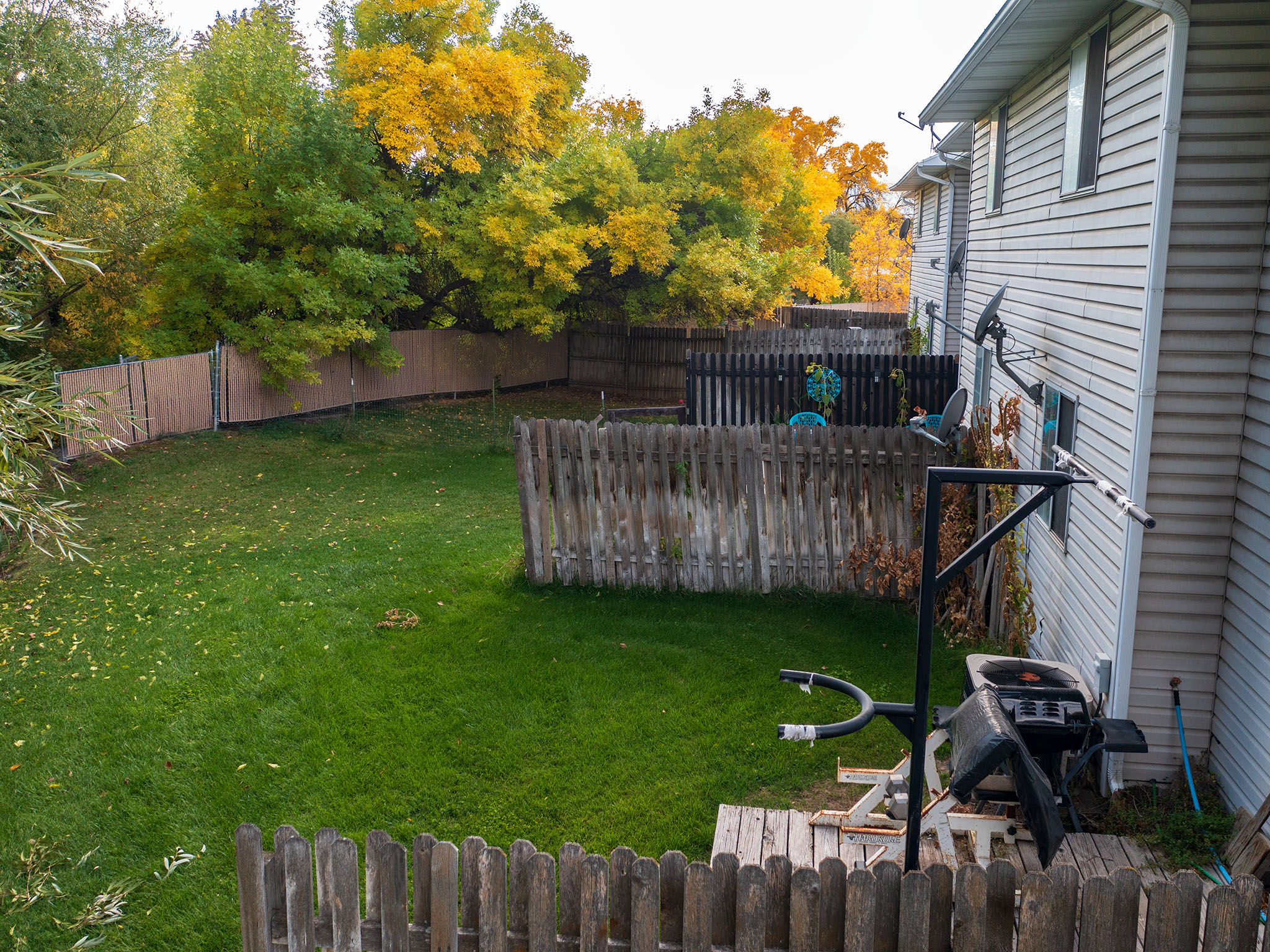 Fenced backyard featuring radiator