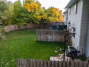 Fenced backyard featuring radiator