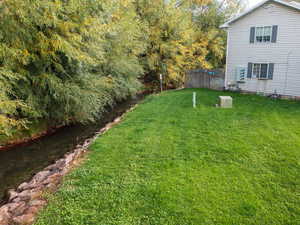 View of yard with a water view