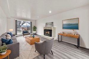 Living room featuring a fireplace, light wood-type flooring, and recessed lighting