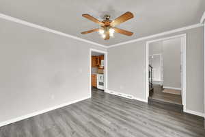 Unfurnished bedroom featuring crown molding, wood finished floors, and ceiling fan