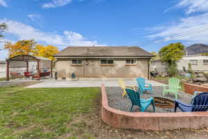 Back of property featuring a patio area, brick siding, an outdoor fire pit, roof with shingles, and a gazebo