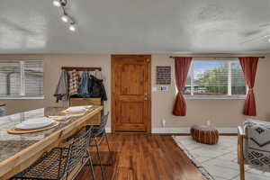 Bathroom with a textured ceiling, dark wood finished floors, and ceiling fan