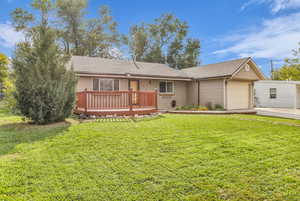 View of front facade with a front lawn, roof with shingles, an attached garage, brick siding, and concrete driveway
