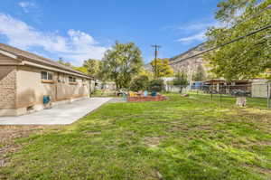 Fenced backyard with a patio and a mountain view