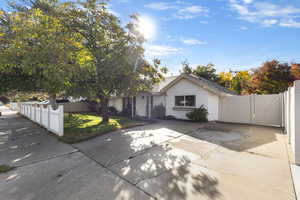 View of front facade with stucco siding and a gate