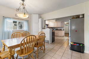 Dining room featuring light tile patterned floors and baseboards