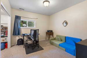 Carpeted office space with baseboards