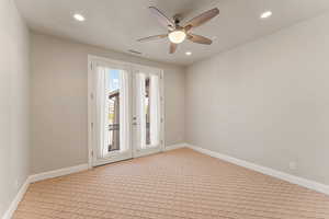 Spare room featuring french doors, recessed lighting, a ceiling fan, and light carpet