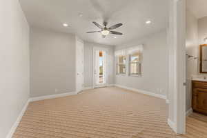 Unfurnished room featuring ceiling fan, recessed lighting, light carpet, and a textured ceiling