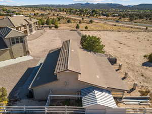 Aerial view of property and surrounding area featuring mountains