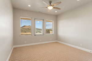 Carpeted spare room with recessed lighting and a ceiling fan