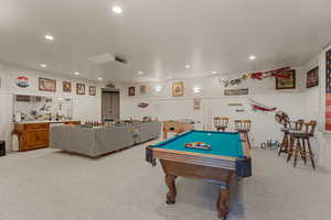 Game room featuring billiards table, light carpet, recessed lighting, and a wainscoted wall