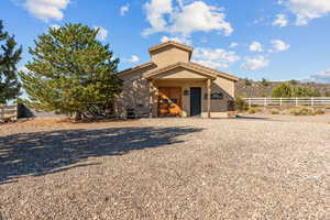 Barn and stables featuring stucco siding and a tile roof