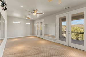 Bedroom with french doors, ceiling fan, recessed lighting, light carpet, and a mountain view