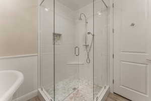 Full bathroom with a stall shower and a freestanding bath