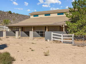 View of front of home with an exterior structure, an outbuilding, and stucco siding