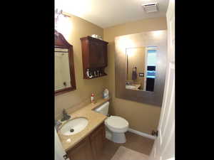 Bathroom featuring vanity and toilet