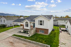 View of front of house with brick siding, concrete driveway, a carport, and a shingled roof