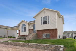 Split level home with brick siding