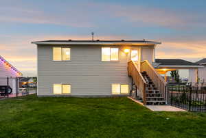 Back of property at dusk with stairway and a gate