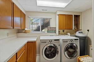 Laundry area featuring cabinets and counter space all around