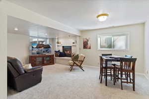 Open area for recreation featuring gas fireplace.