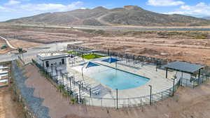 Community pool with a patio and a mountain view
