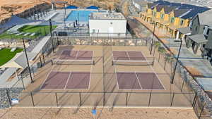 View of tennis court with a patio area and a pergola